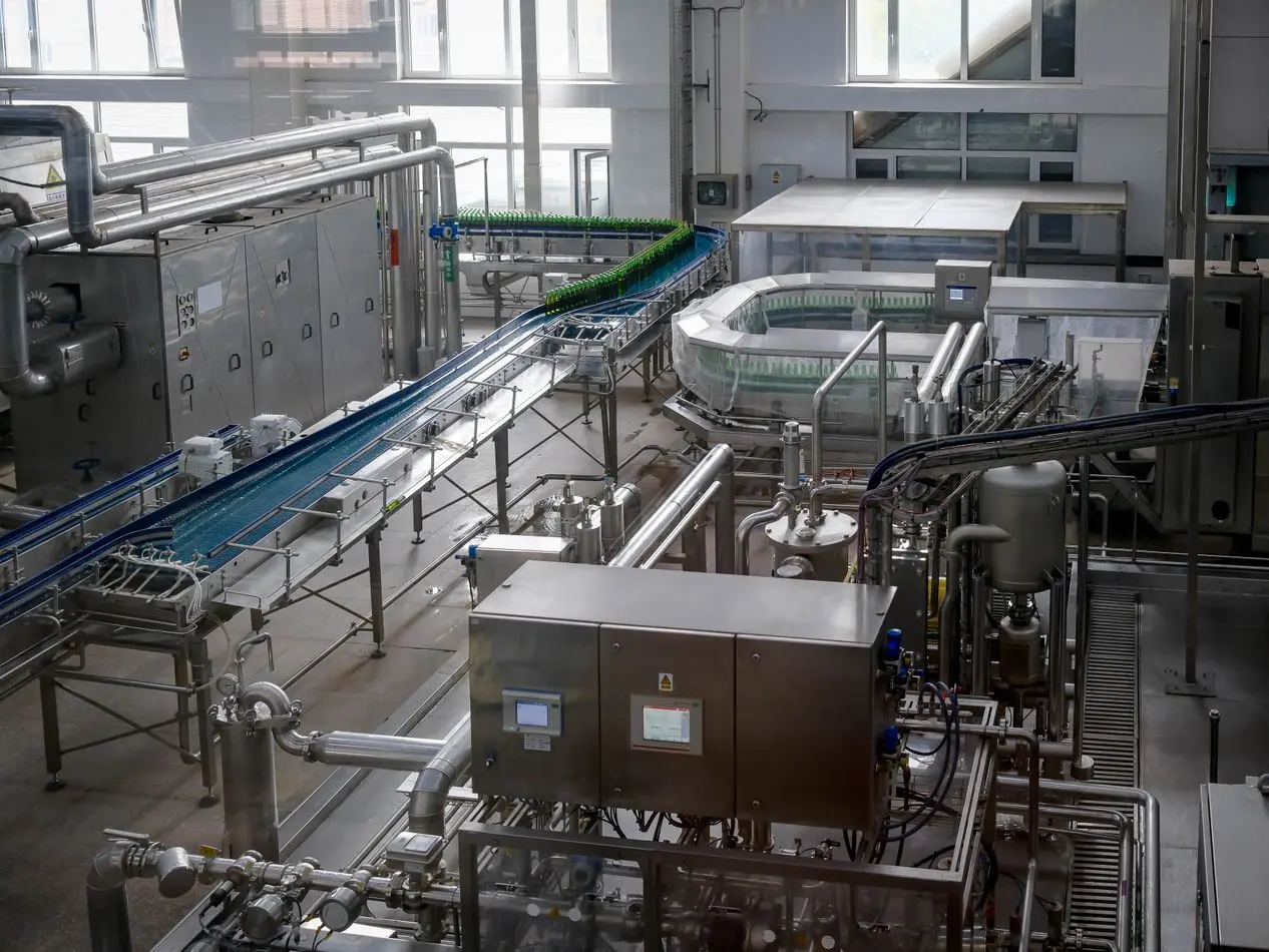 Automated beverage production line with conveyors and machinery