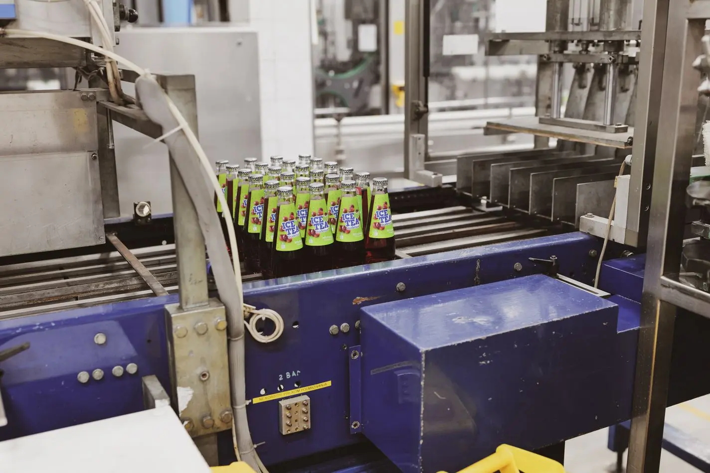 Glass bottles travelling along an automated production line